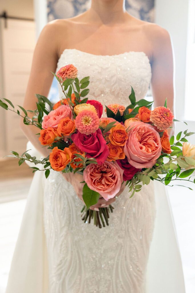 a woman in a white dress holding a bouquet of flowers