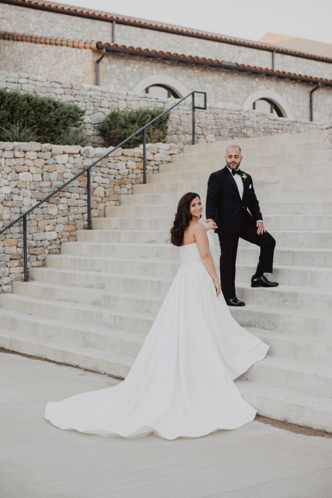 a man in a suit and a woman in a white dress on stairs , wedding timeline