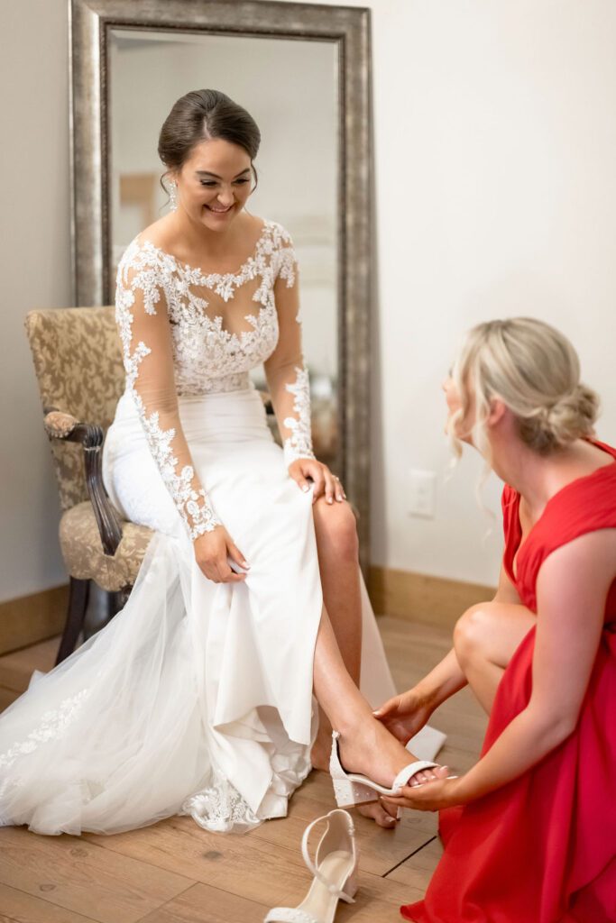 a woman in a white dress sitting in a chair putting on her shoes , 7 Must-Have Steps for the Ultimate Wedding Photography Poses Checklist
