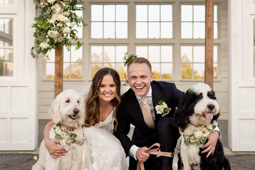 a man and woman with dogs , 8 Tips for Incorporating Pets into Your Wedding Photos