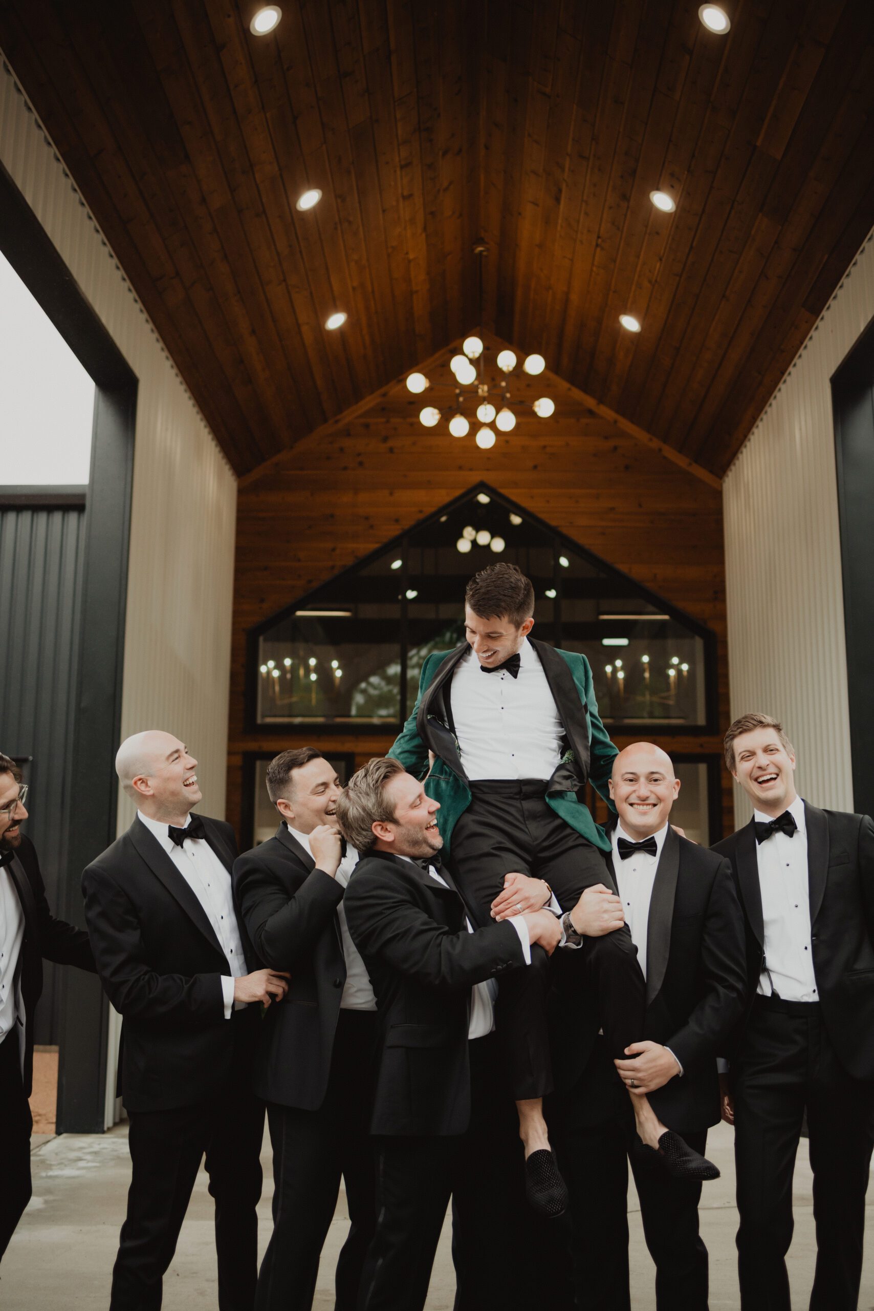 Emerald green groom with black tuxedo groomsmen at Union House fall wedding photographed by Bushel + Peck Photo