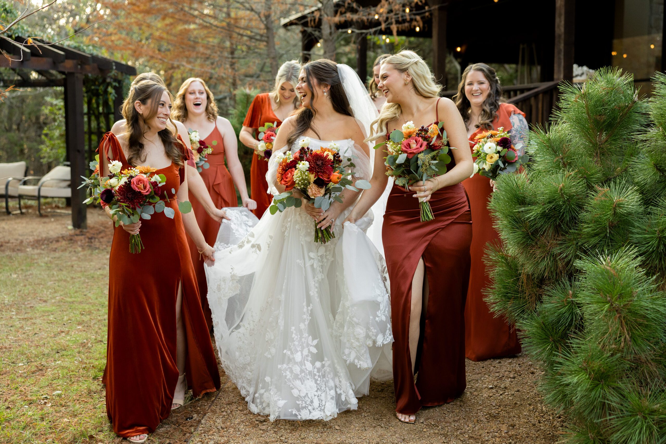 Burnt orange and cinnamon bridesmaid dresses with ivory bridal gown at Avalon Legacy Ranch fall wedding photographed by Bushel + Peck Photo