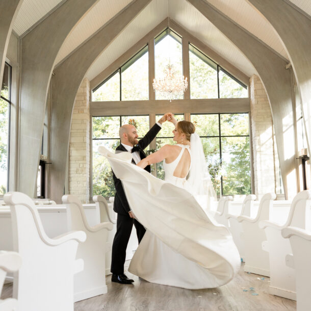 Bride and groom dancing inside Brighton Abbey chapel wedding ceremony space photographed by Bushel + Peck Photo