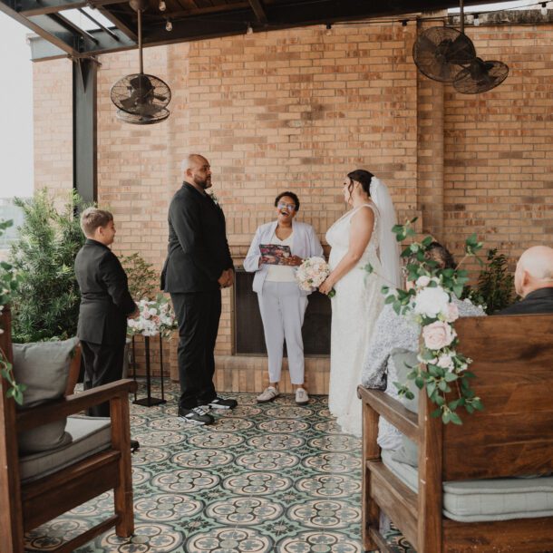 Couple standing during an intimate wedding ceremony at Hotel Emma in San Antonio photographed by Bushel + Peck Photo.
