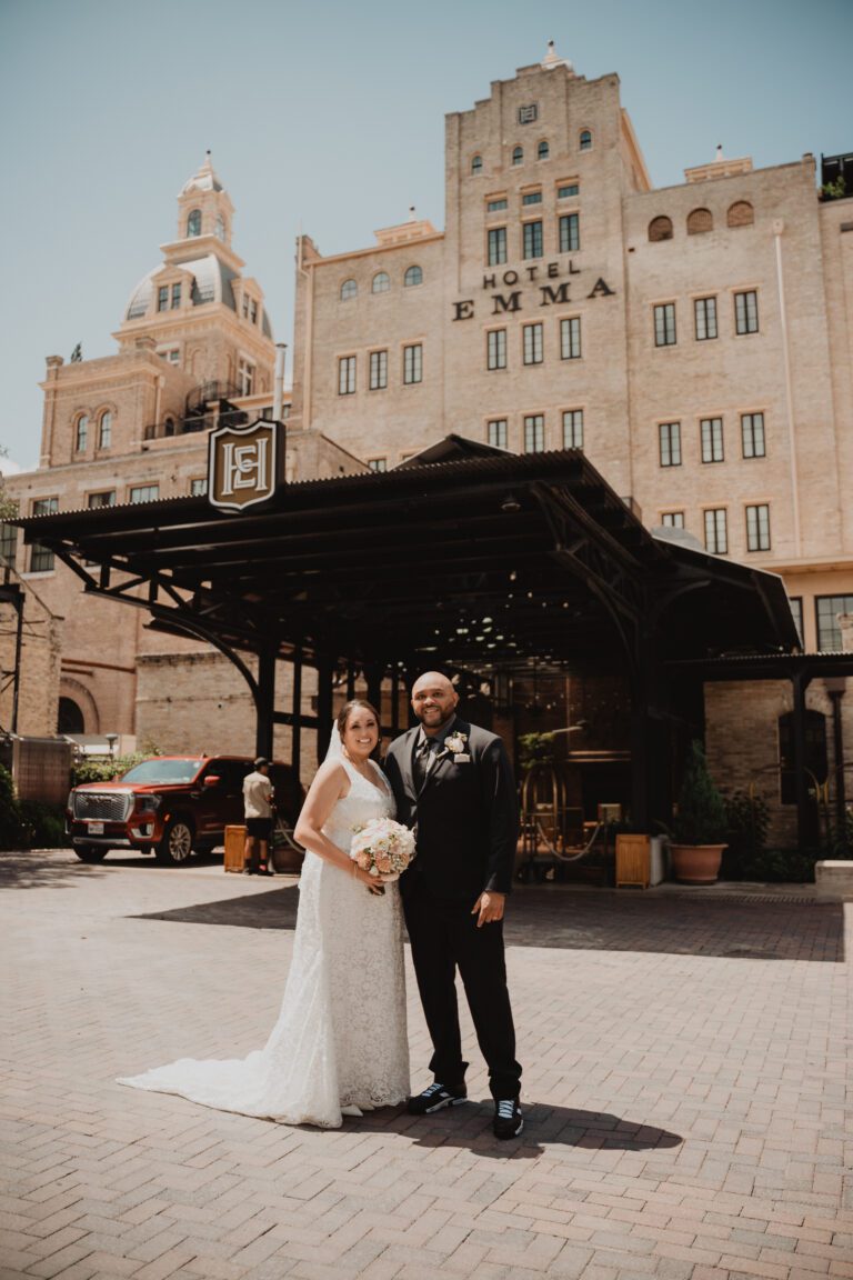 Bride and groom standing outside Hotel Emma in San Antonio’s Pearl District photographed by Bushel + Peck Photo.