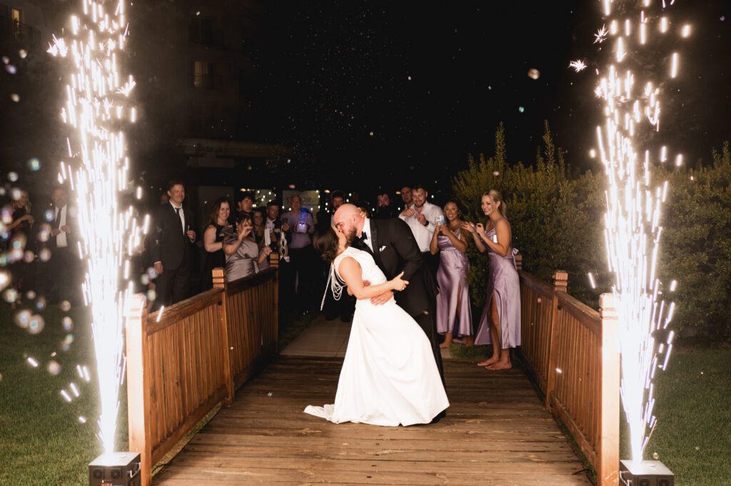 Bride and groom kissing during a nighttime sparkler fountain exit at La Cantera Resort in San Antonio, captured by Bushel + Peck Photo