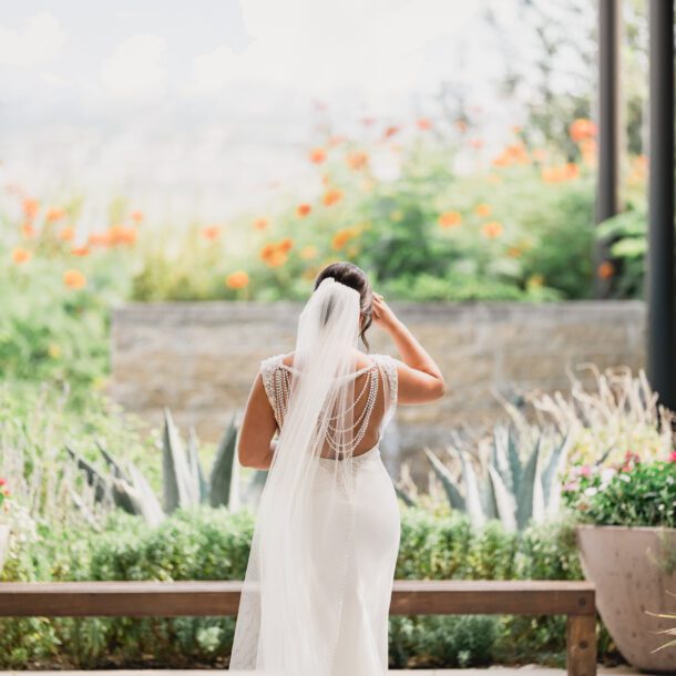 Bride standing with her veil flowing at La Cantera Resort in San Antonio photographed by Bushel + Peck Photo.