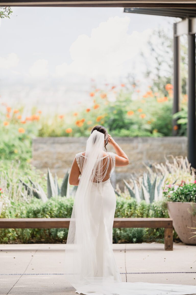 Bride standing with her veil flowing at La Cantera Resort in San Antonio photographed by Bushel + Peck Photo.