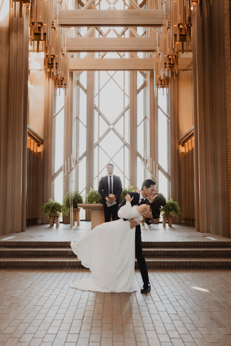 Bride and groom first kiss during their ceremony at Marty Leonard Community Chapel in Fort Worth photographed by Bushel + Peck Photo.