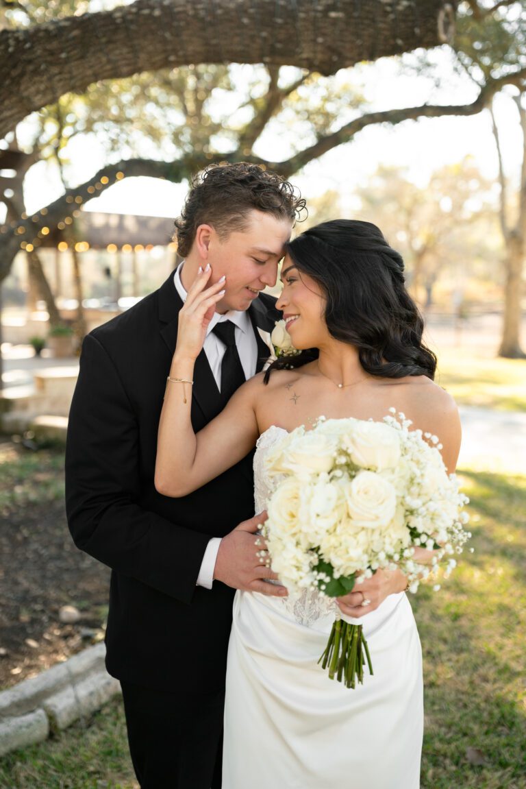 Bride and groom portrait under oak trees at The Ranch Austin photographed by Austin wedding photographers Bushel + Peck Photo.