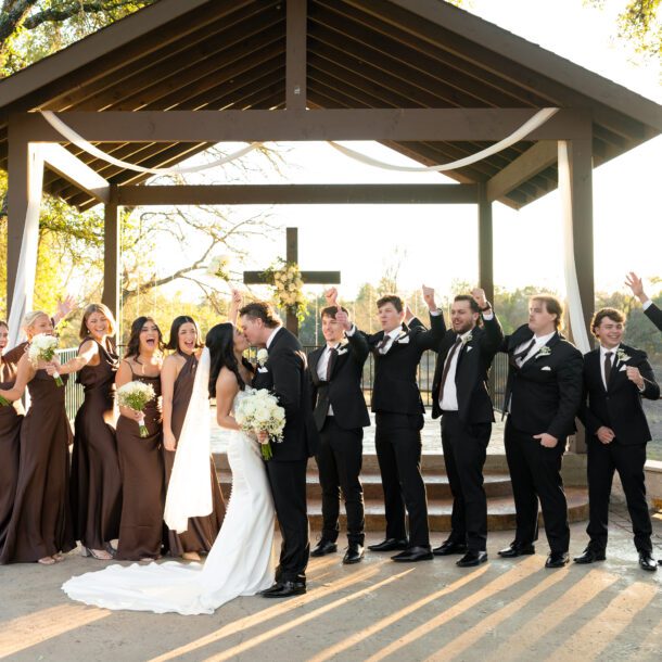 Bride and groom celebrating with their wedding party at The Ranch Austin ceremony pavilion photographed by Austin wedding photographers Bushel + Peck Photo.