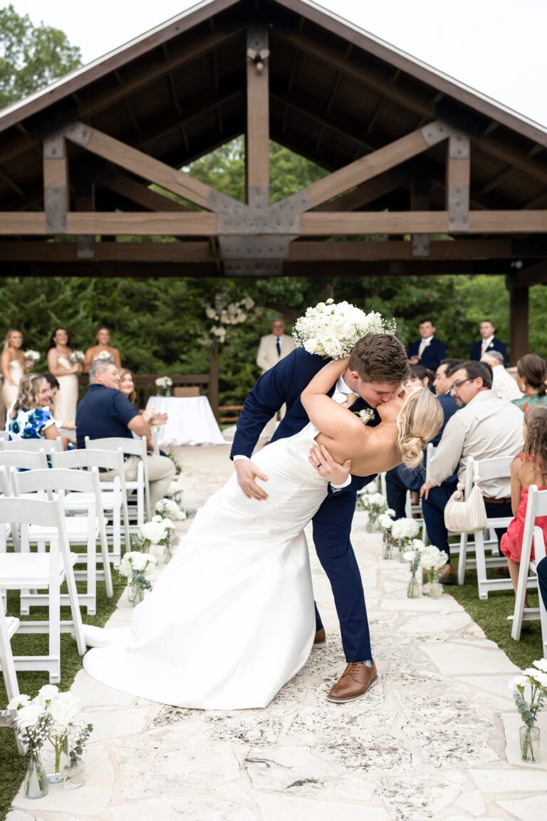 Wedding ceremony kiss at The Springs Event Venue near Fort Worth captured by Bushel + Peck Photo Fort Worth wedding photographers.