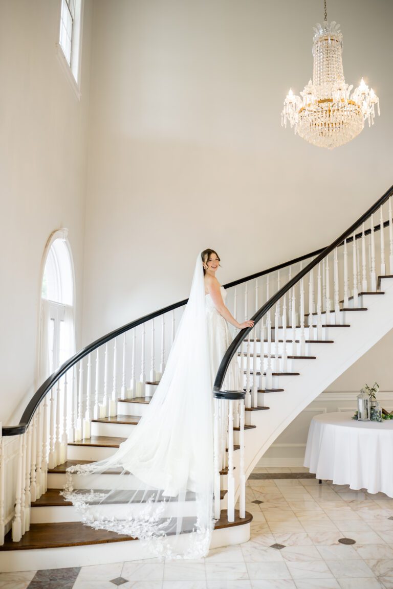 Bride standing on the staircase at The Mansion at ColoVista wedding venue near Austin photographed by Bushel + Peck Photo.