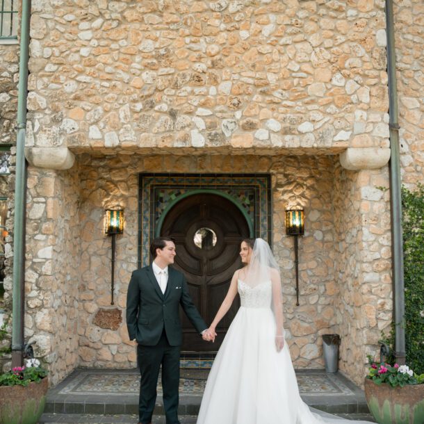 Bride and groom portraits in front of the historic stone building at The Veranda wedding venue in San Antonio photographed by Bushel + Peck Photo.