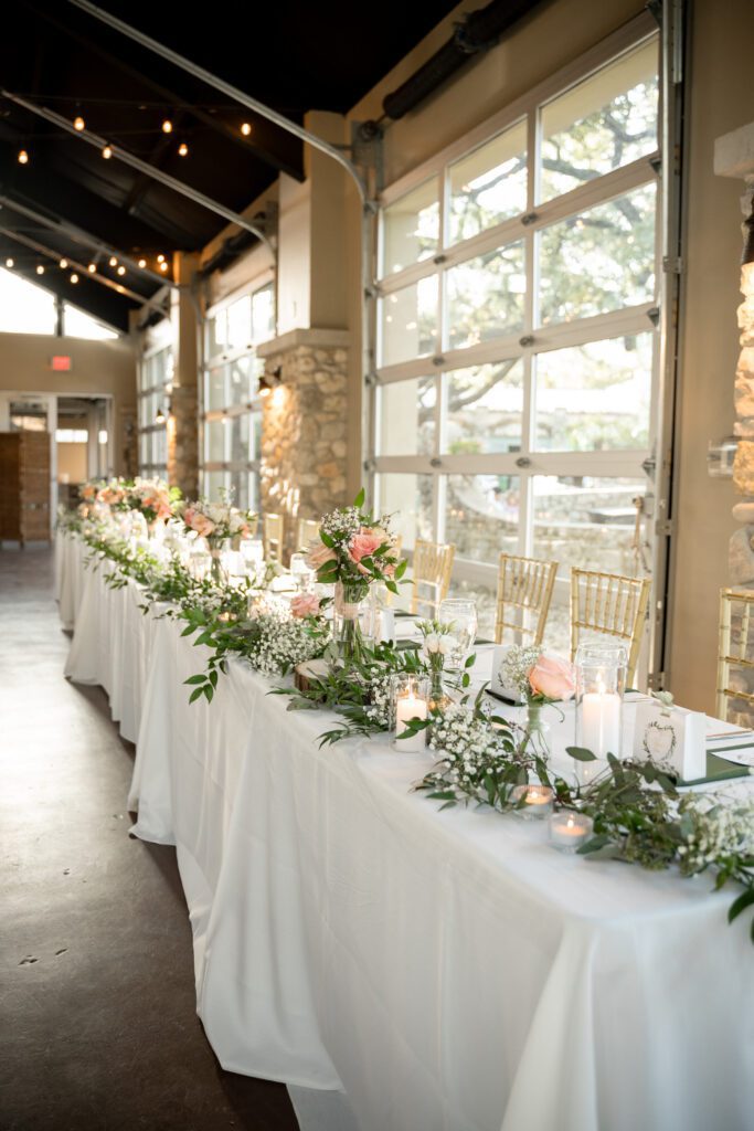 Wedding reception table with floral centerpieces and candles at The Veranda in San Antonio, captured by Bushel + Peck Photo
