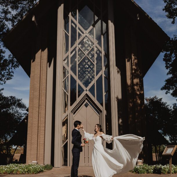 Bride's dress twirls as the couple pose outside Marty Leonard Community Chapel in Fort Worth — Bushel + Peck Photo Fort Worth wedding photographer