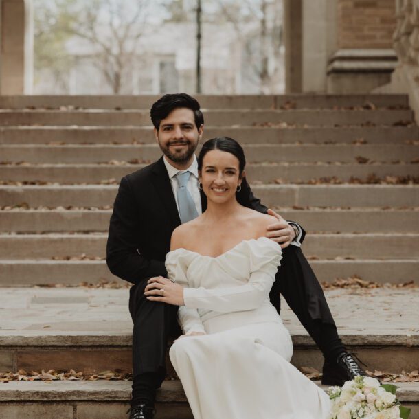 Bride and groom seated on the stone steps at Highland Park United Methodist Church in Dallas after their micro wedding, captured by Bushel + Peck Photo