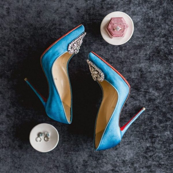 a pair of blue high heeled shoes with diamonds and a ring. Wedding-Photography
