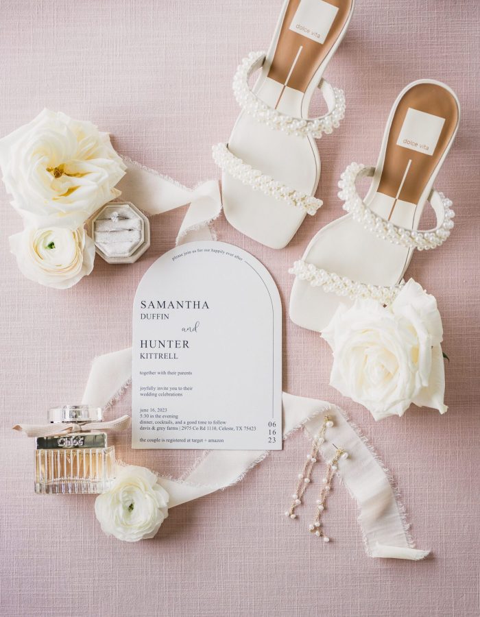 a white sandals with pearls and flowers. Photo by Bushel + Peck Photo, Texas Wedding Photographers